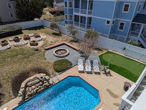 Backyard Amenities include pool, hot tub, tiki bar, fire pit AND putting green!