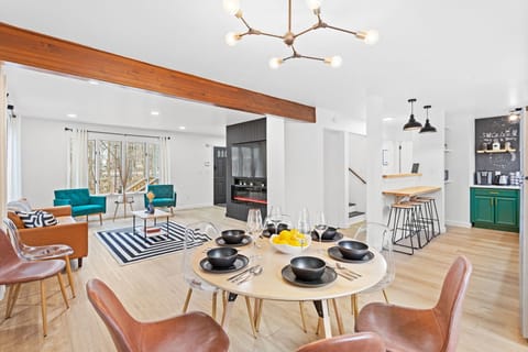 The airy flow from the dining area to the living room makes this space perfect for entertaining, with warm textures and modern design elements.