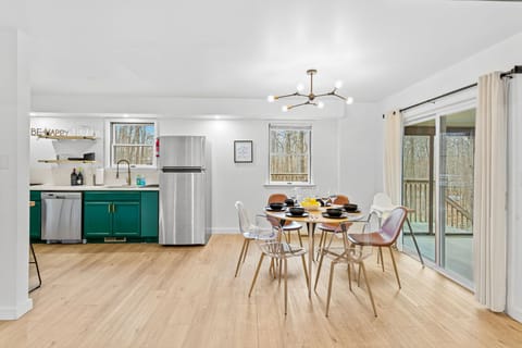 A stunning dining area with contemporary lighting, a spacious layout, and easy access to the kitchen, perfect for gathering and sharing meals.