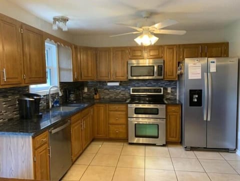 Full kitchen with ice maker, dishwasher, double oven, coffee machine, microwave