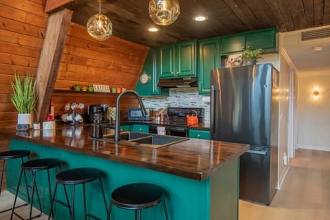 Enjoy our modern kitchen, equipped with stainless appliances like a dishwasher, glass cooktop, and large fridge