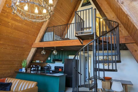 Uniquely designed A-frame showcasing an elegant spiral staircase, adding architectural charm and character to the living space.