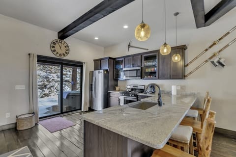 Solid stone counter tops for you to prep or sit back and relax at the bar area. 