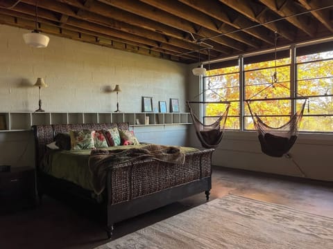 Main bedroom with swinging hammocks - sit and read or enjoy a cup of coffee or tea
The decorative cubbies above the bed are original to the 1949 SchoolHouse. 