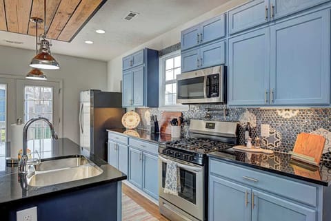 The fully equipped kitchen has everything you need, including cooking utensils, dishes, and cups. A coffee bar, complete with sugar and creamer, adds convenience, and the island seats 3 comfortably for dining or meal prep.