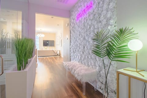 Where Instagram dreams begin: Our designer white flower wall paired with glowing neon creates the perfect backdrop for your Colorado memories
