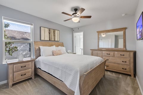 Enjoy restful nights in our beautifully designed bedroom, featuring a warm wood bed frame and matching nightstands. The soft neutral tones and natural light create a cozy atmosphere, ideal for relaxing after your daily adventures.