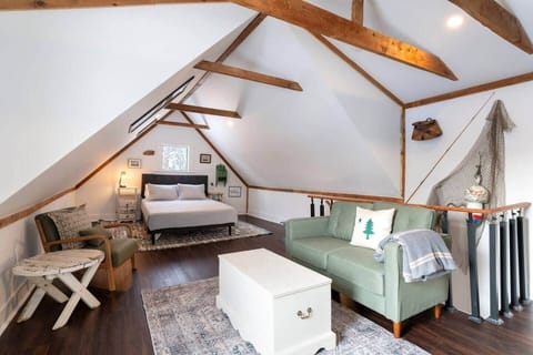 Old carriage house attic converted into an amazing living room and bedroom. With working desk and couch.