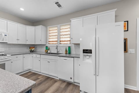 Updated and fully-equipped kitchen with granite countertops.