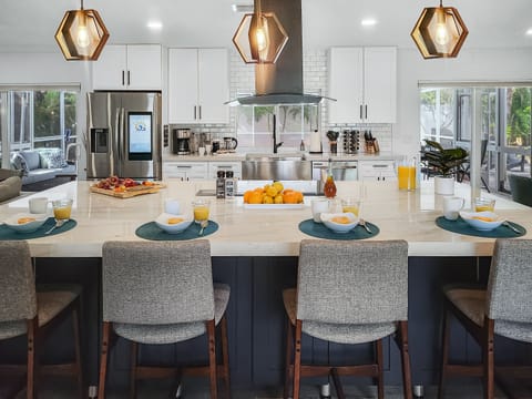 The gourmet kitchen with massive granite-topped island has seating for 4 and is fully equipped for effortless entertaining.