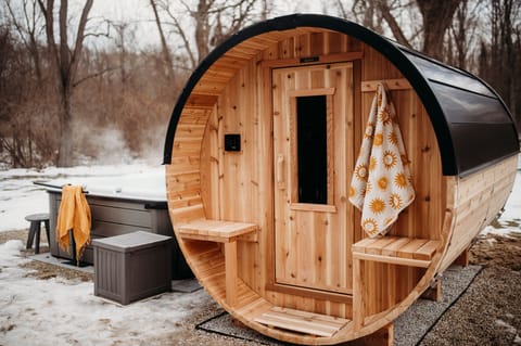10 foot long cedar barrel sauna for six. Heats up in 10–15 minutes.