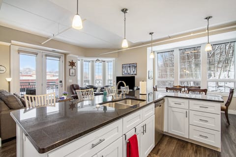 Full kitchen overlooks the rest of the condo and views of the River through the windows