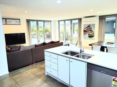 Open plan kitchen & dining, with comfortable sitting room and large TV