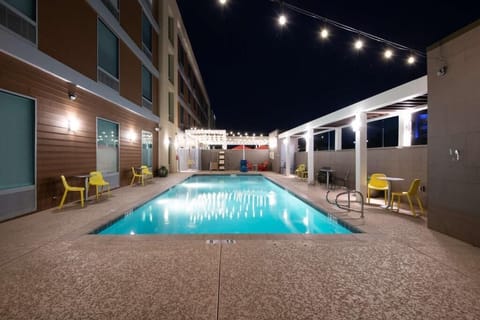 Unwind under glowing lights with a refreshing evening swim.