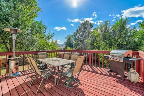 Sun-soaked deck wrapped in greenery—sip coffee at the outdoor table, let the breeze roll through, and fire up the grill for an easy backyard meal.