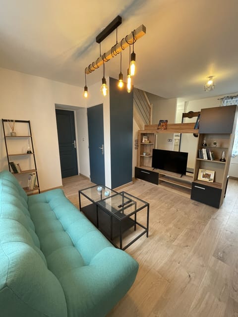 "Bright living room with green sofa and refined decoration".