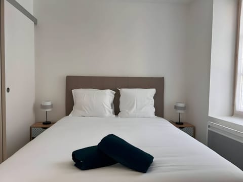 "Enjoy the warm atmosphere of the "Le Donjon" apartment's bedroom. Take advantage of the office space to work or relax."