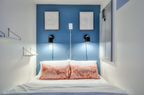 Queen Bed with ambient lighting and shelves