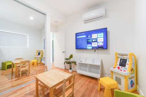 Kids room has small arcade game and 4K TV