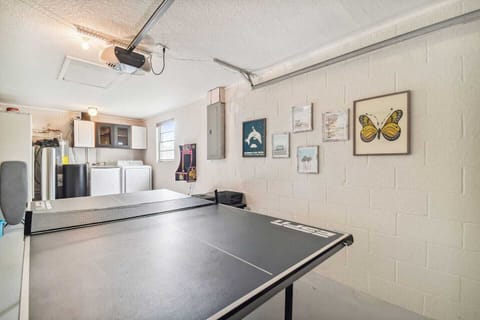 The converted garage is a perfect hangout spot. The ping pong table is set up for competitive play, while the Ms. Pacman arcade machine adds a touch of nostalgia and fun.