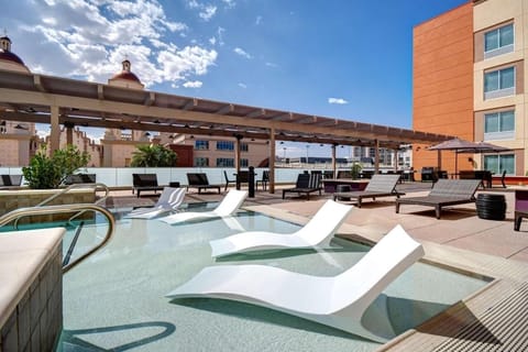 Soak up sunshine lounging in the rooftop pool oasis.