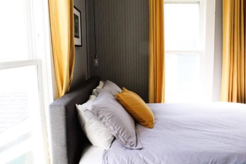 Sink into crisp linens beside bright, breezy windows.