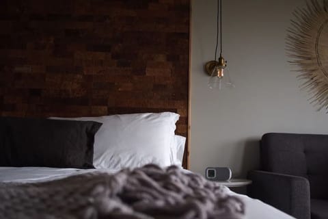 Relax into plush pillows beside warm textures and ambient glow.