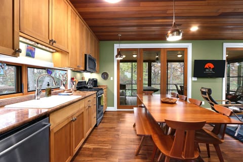 View of the entrance from the sunroom, the kitchen is behind dining