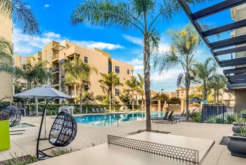 Resort-style pool surrounded by palm trees — perfect for lounging under the sun.
