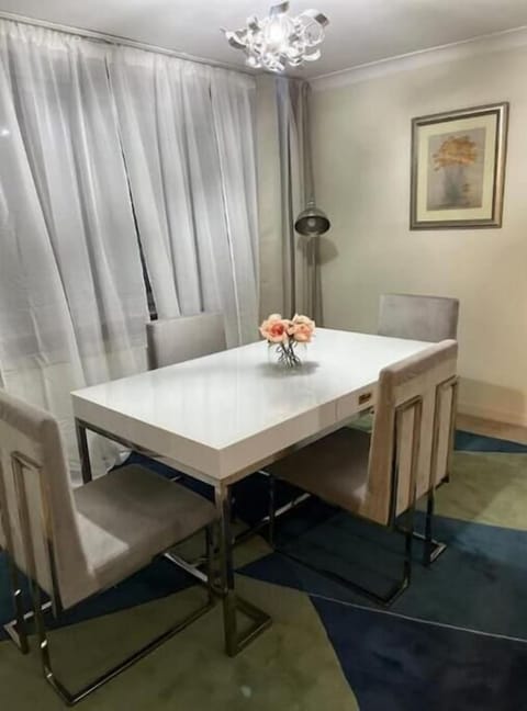 Dining area with large windows and comfortable chairs.