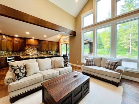 Living room with large picture windows and kitchen