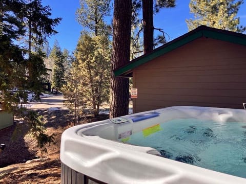 Relax in the outdoor hot tub area, a cozy and peaceful space perfect for unwinding and enjoying fresh air after a long day.