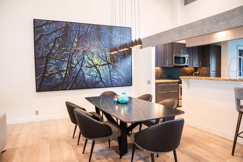 Kitchen: Gather around our stylish dining table for meals or game nights—it's the perfect space to come together. With contemporary art setting the scene and an open-plan kitchen just steps away, it's a spot where memories are waiting to be made.