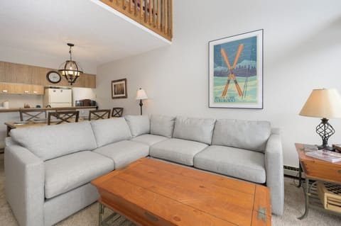Sink into this plush sectional sofa where you'll unwind after mountain adventures. Cozy lighting and ski-themed artwork create your perfect alpine retreat.