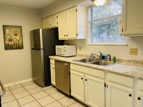 Stainless appliances and garbage disposal in sink. 