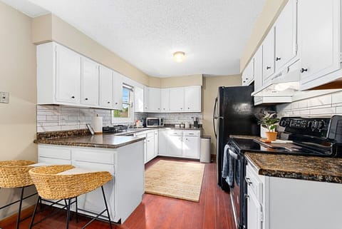 Enjoy morning coffee at the breakfast bar in our bright kitchen.