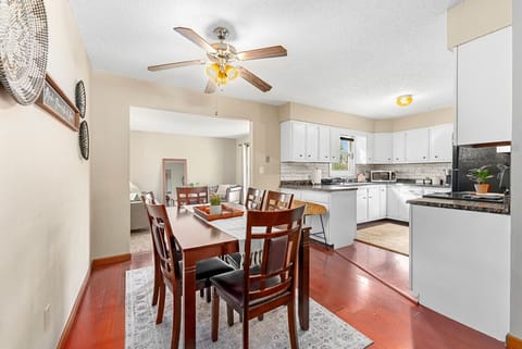 Gather around the dining table with easy access to the spacious kitchen.