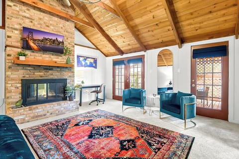 This charming home boasts a warm and inviting atmosphere with its exquisite wooden design furnishings, creating a cozy ambiance that perfectly complements the stylish chairs, adding a touch of