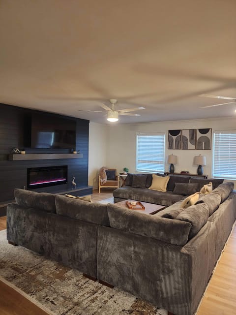 Cozy up by the fire with friends and family with a smart TV, fireplace and bookshelves filled with games. 