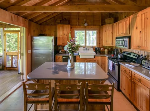 Open kitchen with island and doors to screen porch