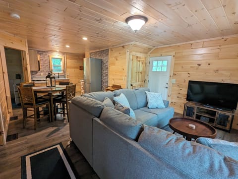 The open floor plan living room, dining area, and kitchen