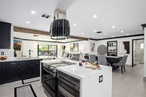 Fully equipped kitchen stocked with your basic cooking essentials, and stainless-steel appliances, bar seating, all connected to the formal and informal living areas and dining area.