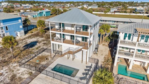 Modern coastal rental with private pool and elevated decks in beachside community.
