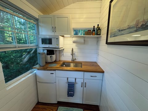 A section of the kitchenette with air fryer, Keurig coffee maker, and microwave