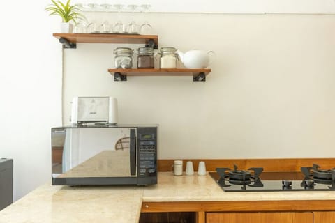 Fully equipped countertop with microwave, toaster, and daily essentials