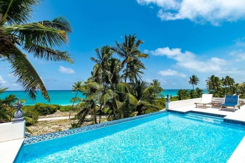 Welcome to Pinapple House.  Just completed in 2022, this beautiful new home sits on a pristine mile-long pink sand beach in the gated community of Wykee Estates.
