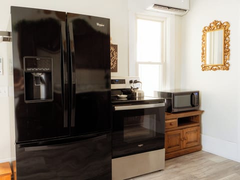 Kitchenette featuring luxury fridge, electric oven, and microwave. 