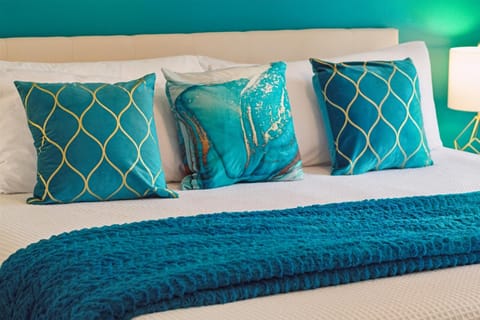 Enjoy a spacious master bedroom with a king-sized bed & blackout curtains.