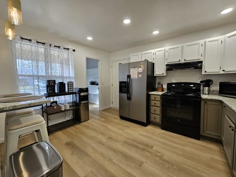 Spacious open kitchen with a coffee bar, water dispenser, and more!