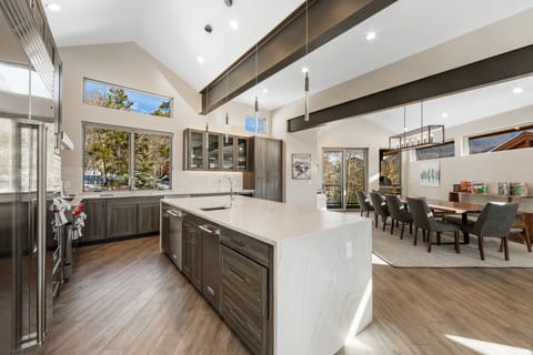 Chef's kitchen with quartz countertops and a dining area with seating for 10.